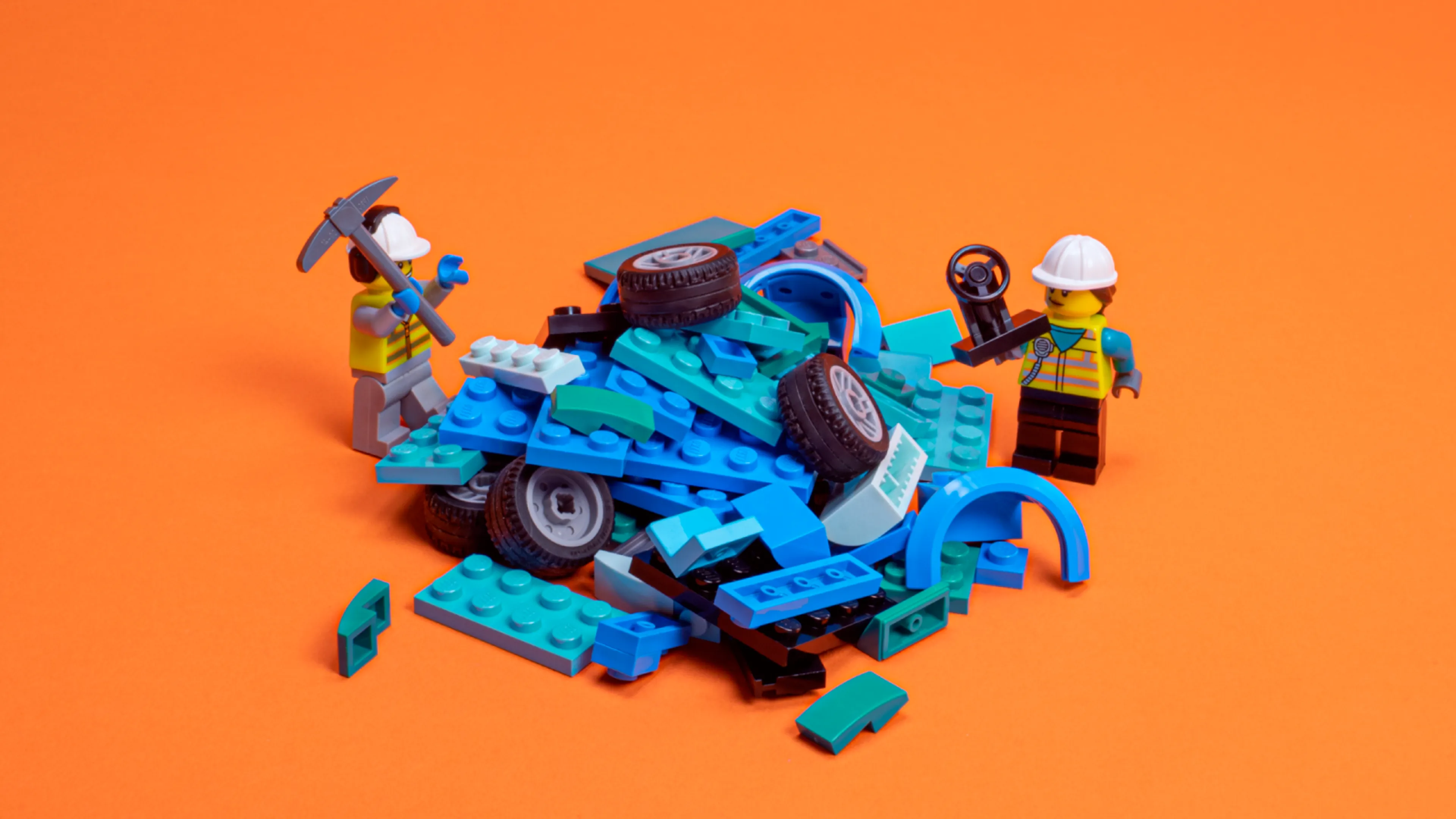 Minifigures and a pile of LEGO bricks and car parts