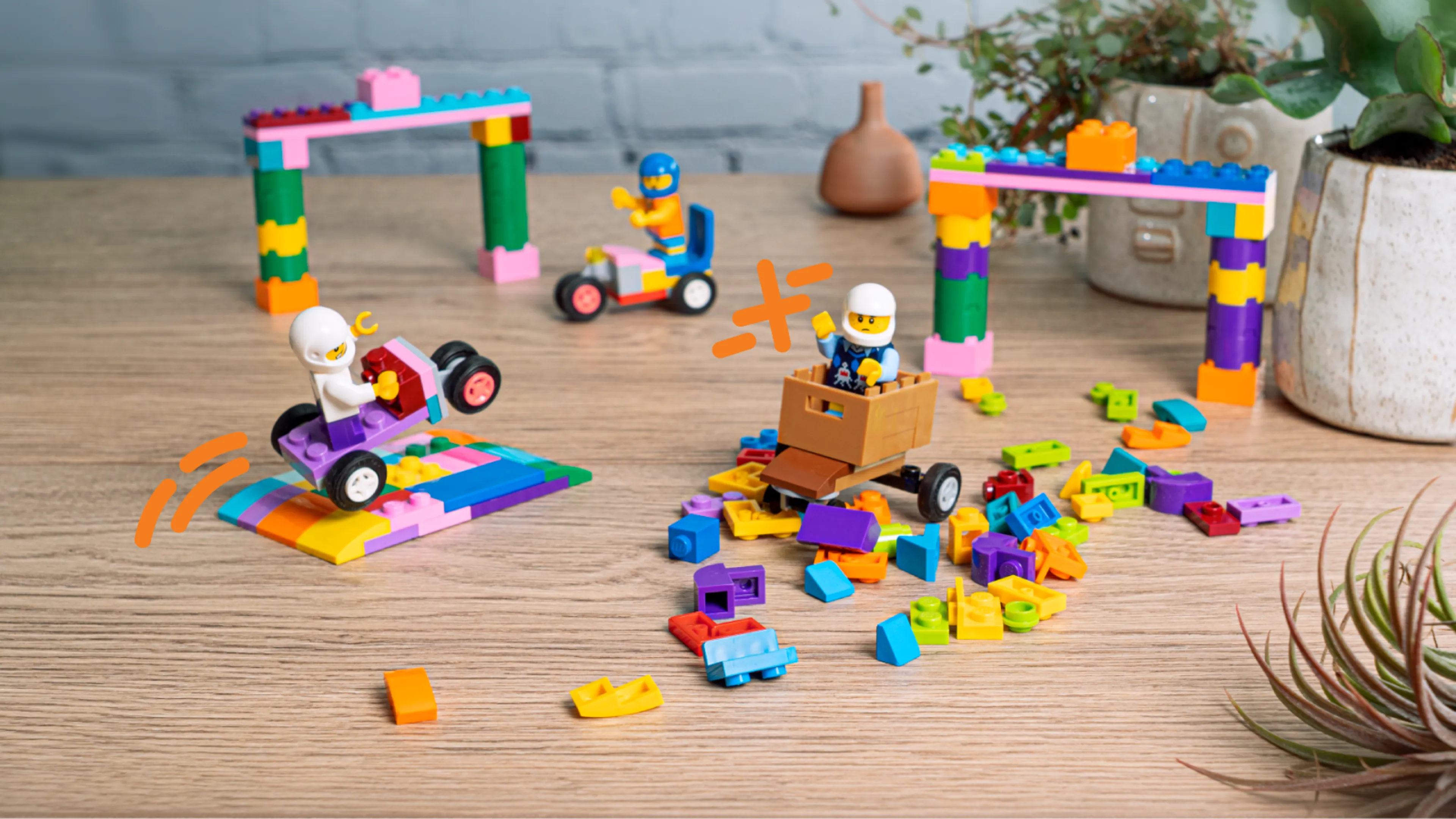 Minifigures, LEGO soapbox cars, gates and a pile of bricks
