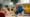 Grandfather and a grandchild playing with LEGO bricks on the floor